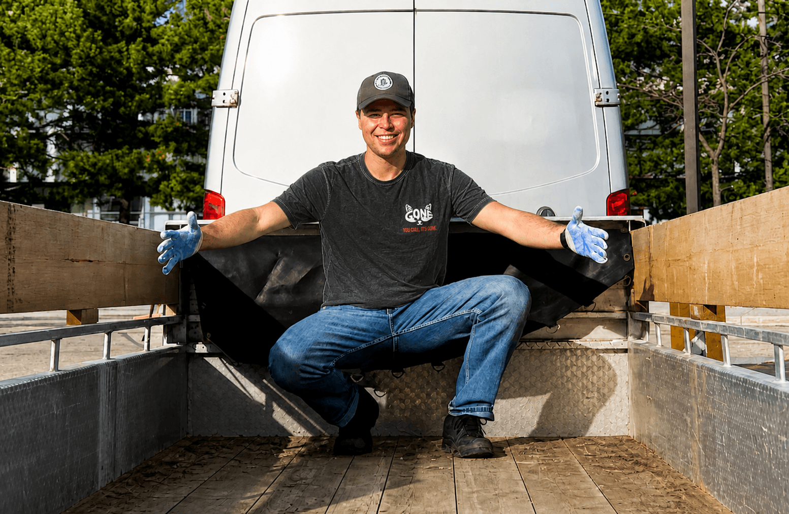 Kacper, owner of ITSGONE, with the junk removal van and trailer.